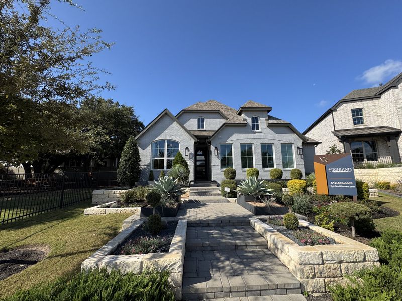 Charming gray brick home with elegant landscaping in Wolf Ranch: 46ft. lots by Highland Homes (Georgetown, TX). Charming gray brick home with elegant landscaping in Wolf Ranch: 46ft. lots by Highland Homes (Georgetown, TX).
