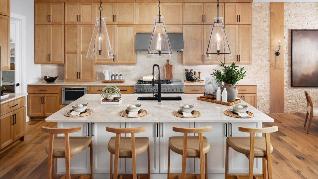 Gourmet kitchens boast a large center island and stainless steel appliances Gourmet kitchens boast a large center island and stainless steel appliances