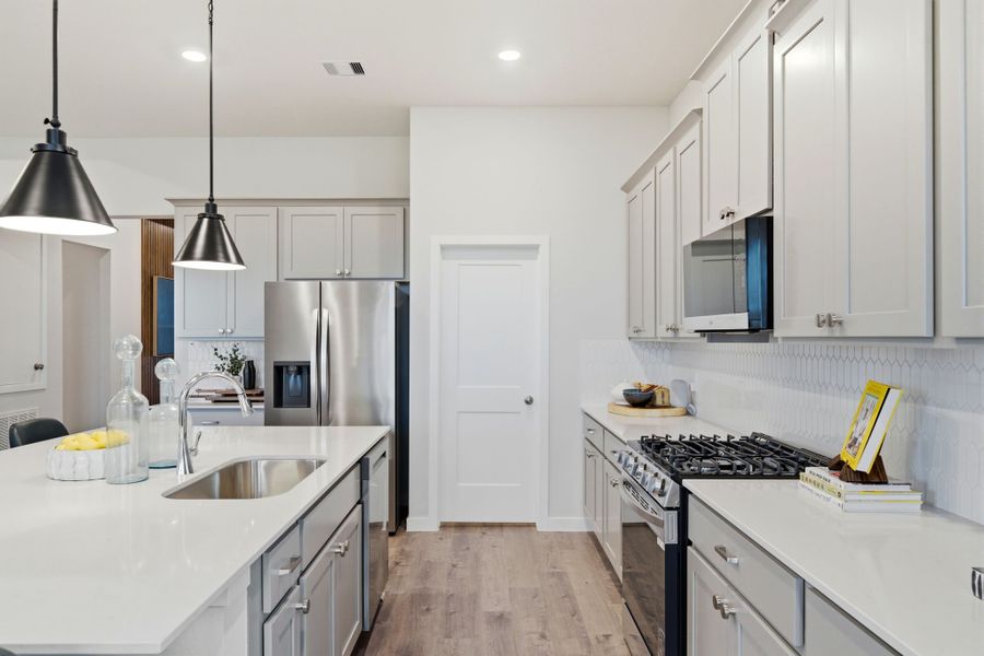 A kitchen with white cabinets. A kitchen with white cabinets.