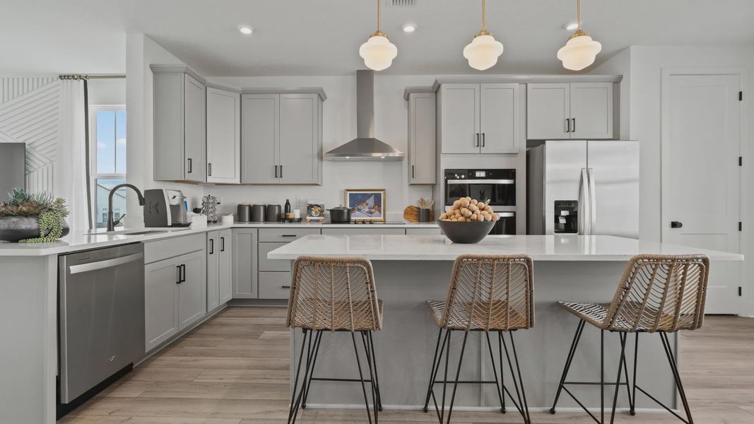 Open-concept gourmet kitchen with sleek gray cabinets and plenty of natural light—style meets function at Parkview at Hamlin