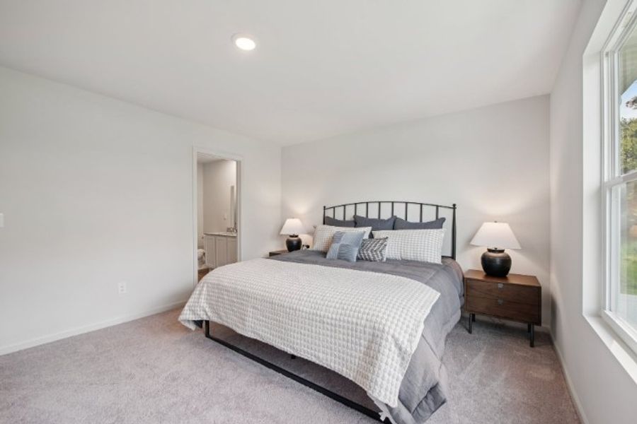 A bedroom with a bed and lamps. A bedroom with a bed and lamps.