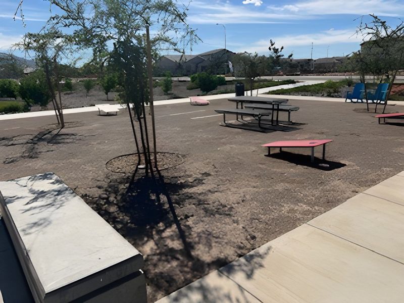 A serene outdoor area with games and seating in Alamar: Premier by Lennar, Avondale, AZ.