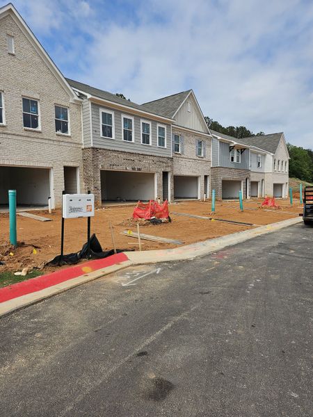 Chic new townhomes with classic brick design under construction in Wildwood Place by Traton Homes (Powder Springs, GA). Chic new townhomes with classic brick design under construction in Wildwood Place by Traton Homes (Powder Springs, GA).