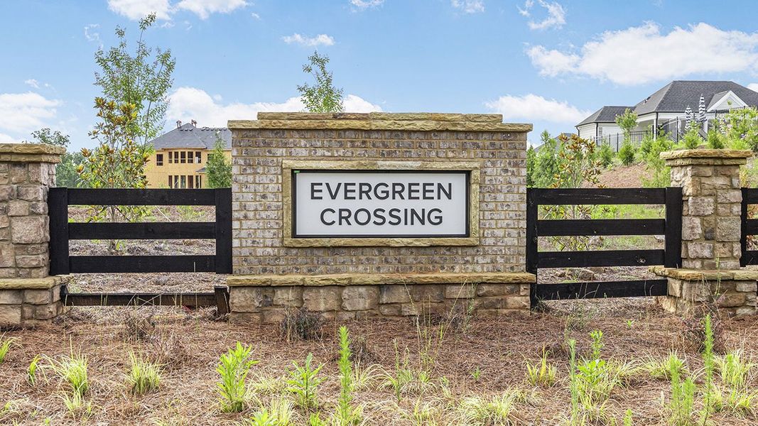 Entrance to the Evergreen Crossing community in Locust Grove, GA, featuring signage and landscaping (Image 1). Entrance to the Evergreen Crossing community in Locust Grove, GA, featuring signage and landscaping (Image 1).