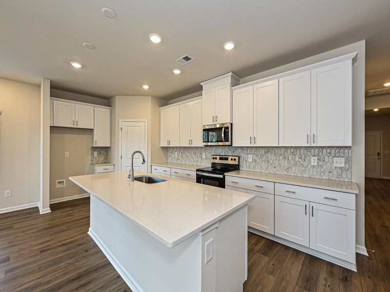 Gather the family around the large kitchen island while cooking dinners.