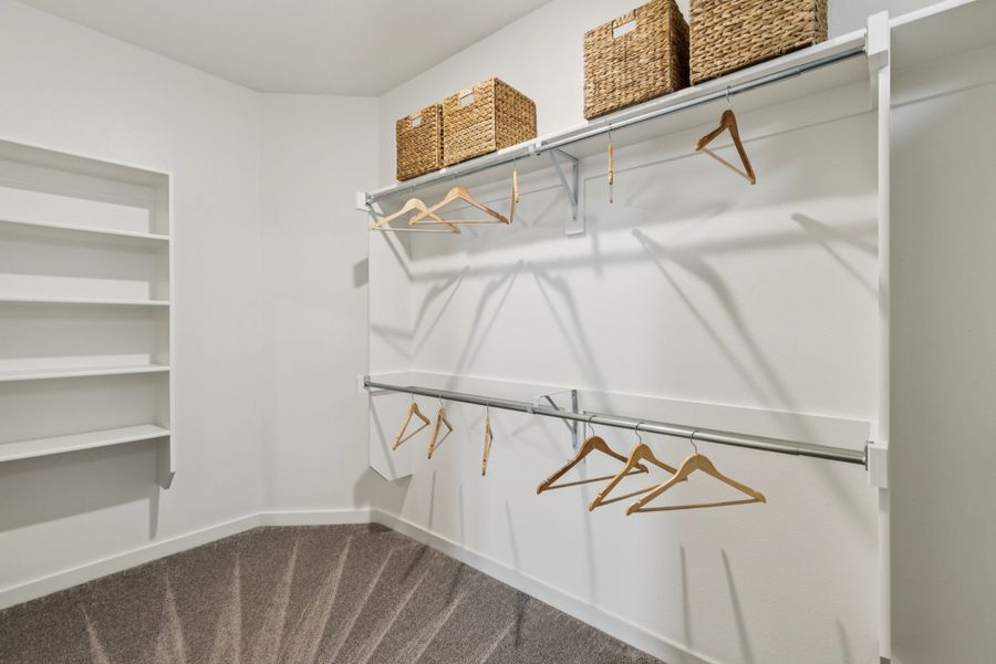 REPRESENTATIVE PHOTO – Primary Closet in a Lakehaven Oak model home in Farmersville TX by Trophy Signature Homes
