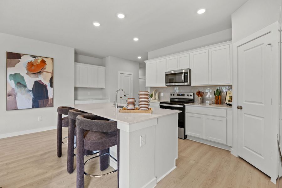 A kitchen with white cabinets. A kitchen with white cabinets.