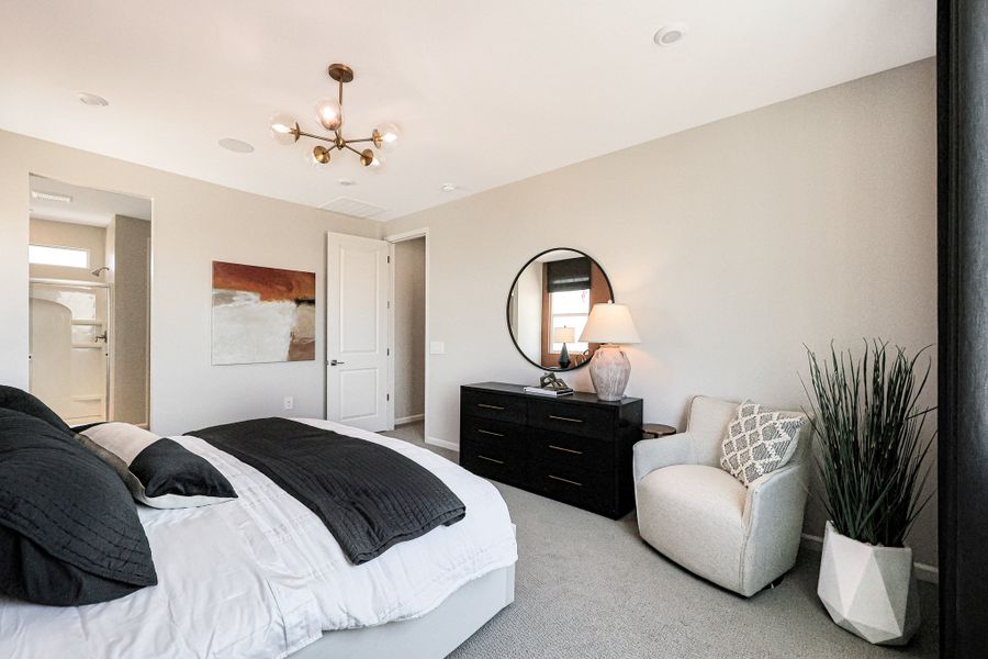 A bedroom with a bed and a chair. A bedroom with a bed and a chair.