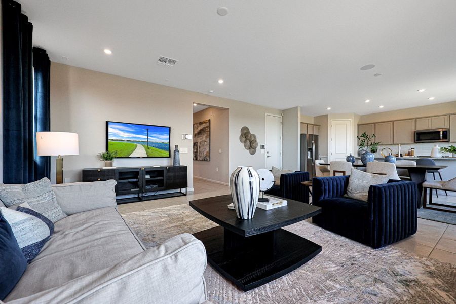 A living room with a tv and couches. A living room with a tv and couches.