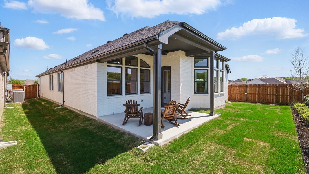 Luxurious white brick facade with spacious patio, elegant gable roof; Green Oaks Preserve. Luxurious white brick facade with spacious patio, elegant gable roof; Green Oaks Preserve.