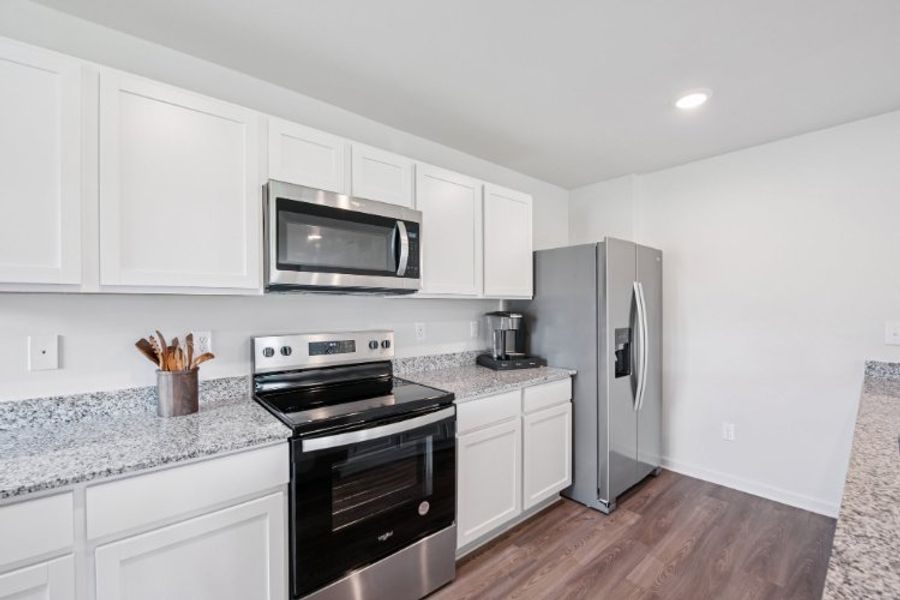 A kitchen with white cabinets. A kitchen with white cabinets.