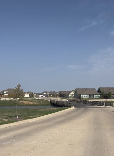A picturesque street leading to charming homes in Enclave at Pecan Creek by D.R. Horton, Providence Village, TX.