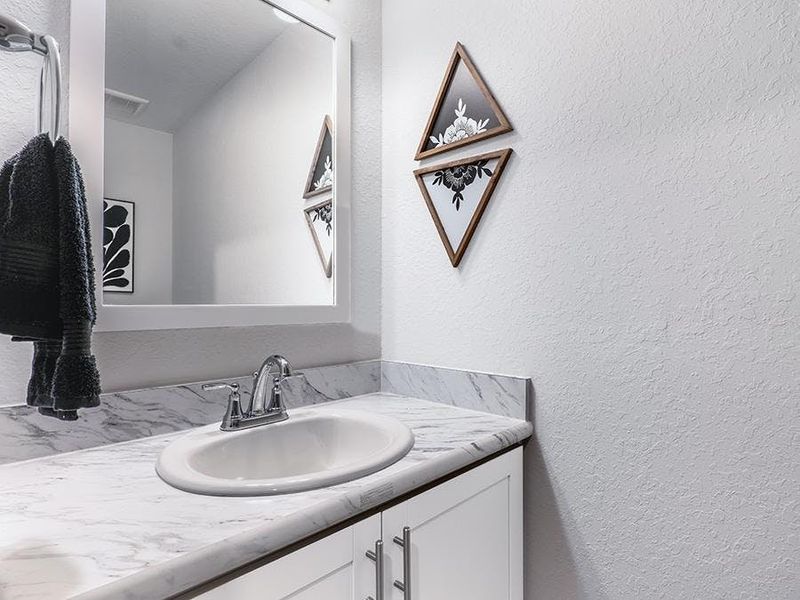 And, a convenient downstairs powder room serves your guests - Azalea townhome plan And, a convenient downstairs powder room serves your guests - Azalea townhome plan