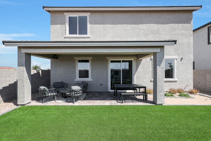A house with a lawn and chairs. A house with a lawn and chairs.