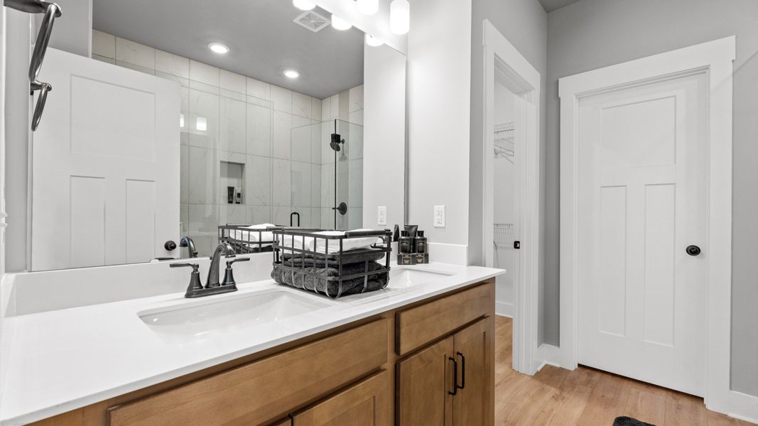 Superior en-suite primary bathroom with stylish dual vanity and tiled walk-in shower crafted with high standards in mind Superior en-suite primary bathroom with stylish dual vanity and tiled walk-in shower crafted with high standards in mind