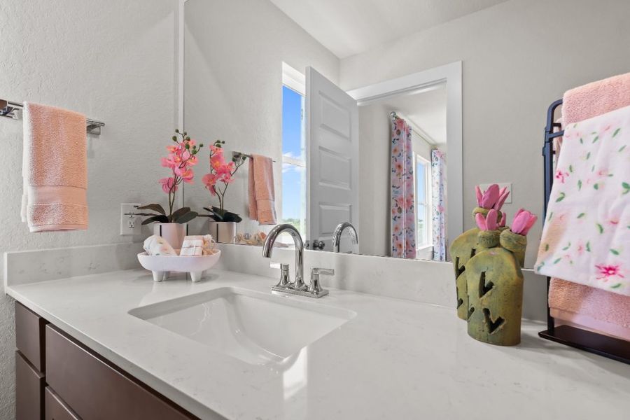 A bathroom with a sink and a mirror. A bathroom with a sink and a mirror.