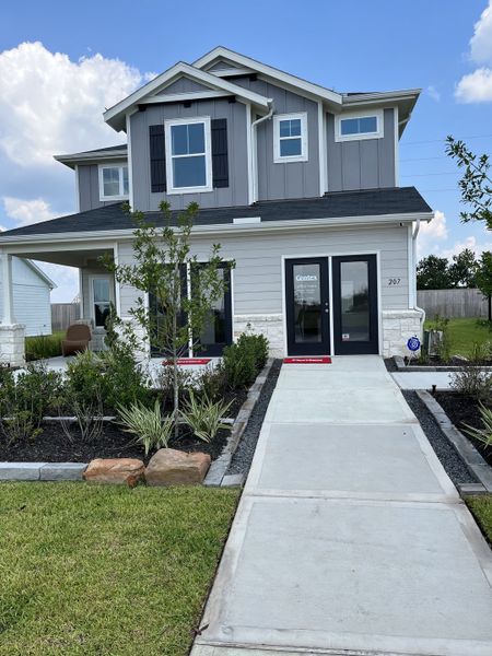 A charming grey two-story home with landscaped garden in Windcress by Centex (Cove, TX).