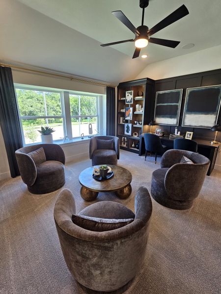 A modern living room featuring plush gray chairs, a sleek coffee table, and a large window with abundant natural light. A modern living room featuring plush gray chairs, a sleek coffee table, and a large window with abundant natural light.