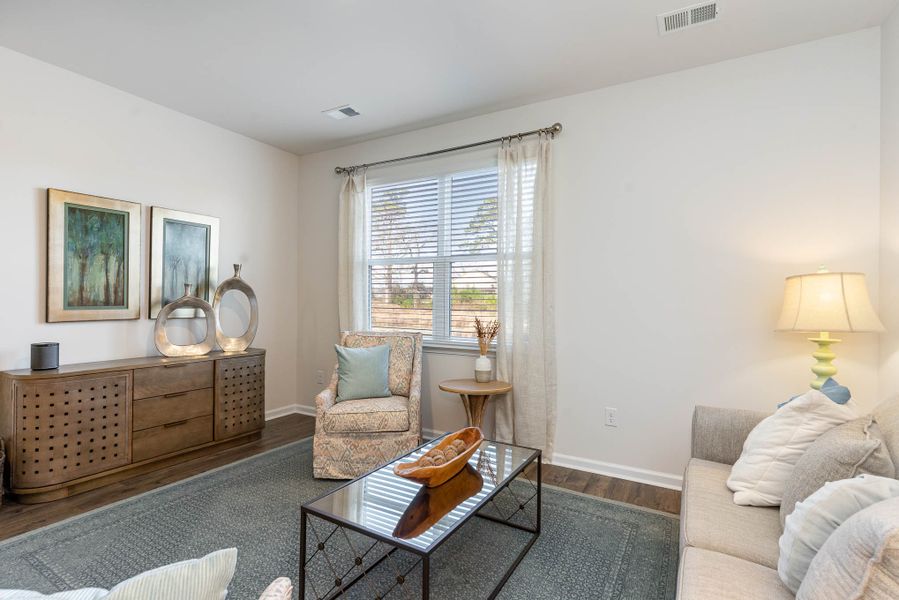 Furnished interior in a model home at Island Green in Myrtle Beach (Image 59).