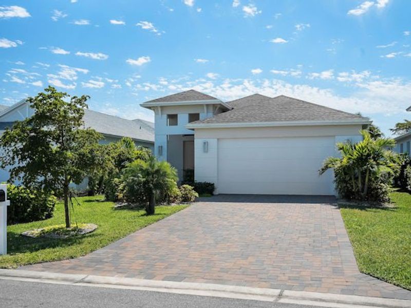 Front exterior of a home in the The Falls at Grand Harbor community, located in Vero Beach, FL (Image 48).
