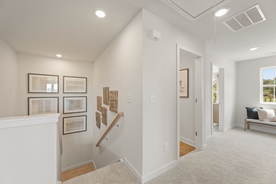 A room with white walls and pictures on the wall. A room with white walls and pictures on the wall.