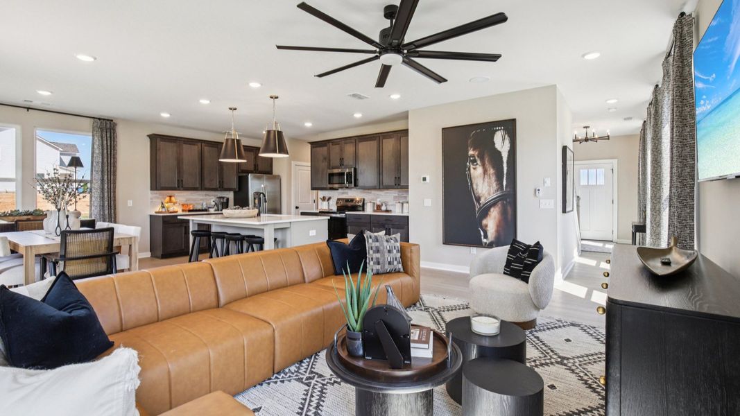 Open Concept first floor layout with cozy living room, kitchen island, and dining area near the back door