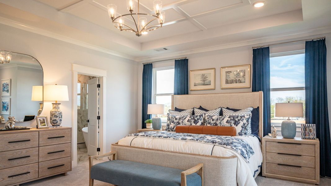 Oversized bedroom with accent trim tray ceiling, and king-sized bed