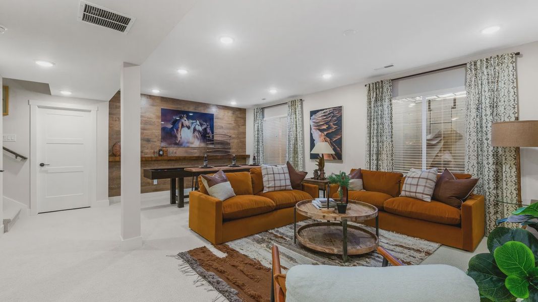 Sophisticated Dillon Pointe room features luxe orange seating, rich wood finishes, and curated art. Sophisticated Dillon Pointe room features luxe orange seating, rich wood finishes, and curated art.