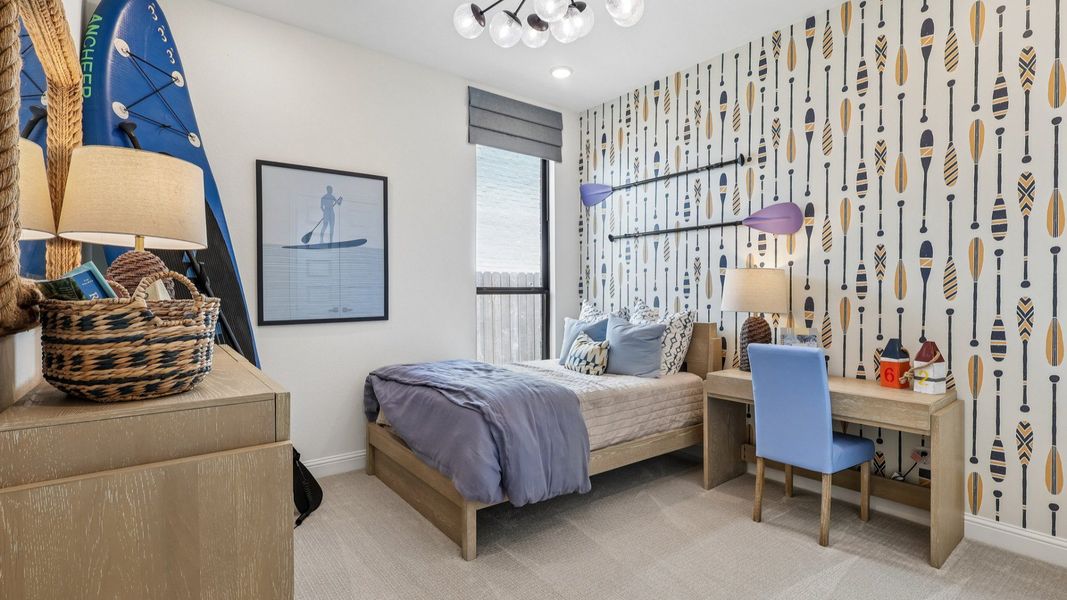 Paddle-themed wallpaper and chic chandelier in Brookewater make this bedroom an exquisite retreat.