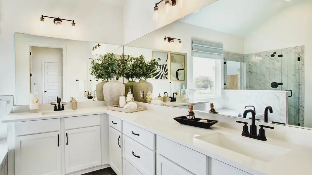 Stunning double vanity, sleek black fixtures, marble shower–elevate your mornings in Veranda.