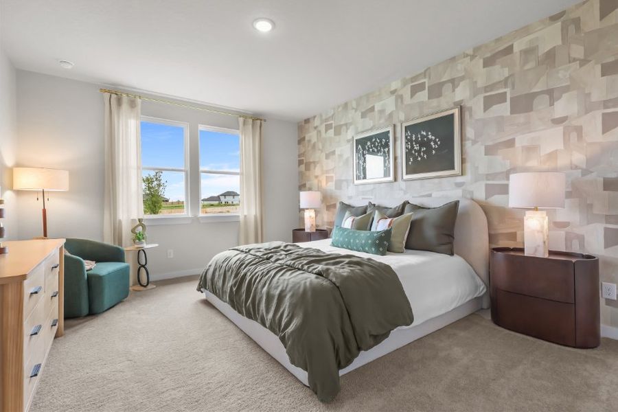 A bedroom with a bed and a chair. A bedroom with a bed and a chair.