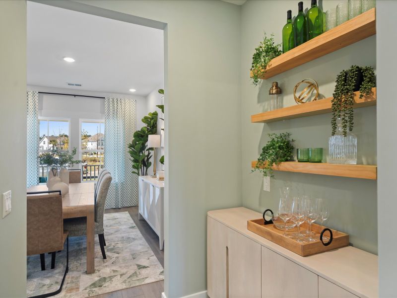Create a beverage area in the space outside the walk-in pantry.