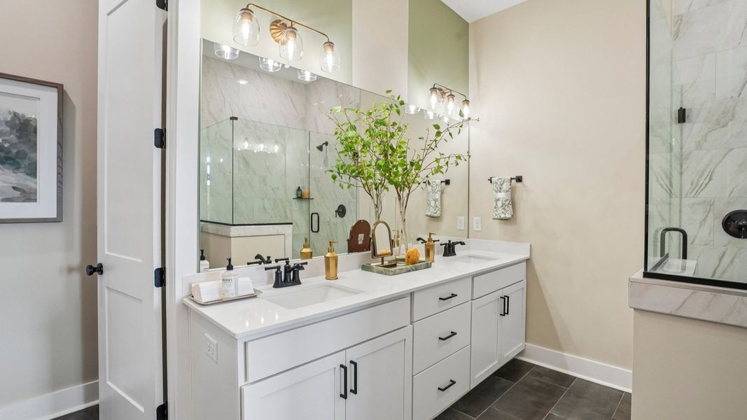 Primary bathroom with dual vanity and glass enclosed shower Primary bathroom with dual vanity and glass enclosed shower