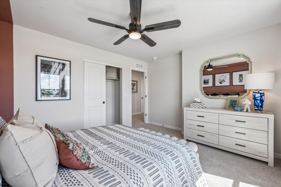 A bedroom with a bed and a fan. A bedroom with a bed and a fan.