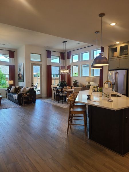 A spacious open-concept living area with a modern kitchen, island seating, and elegant dining space. A spacious open-concept living area with a modern kitchen, island seating, and elegant dining space.