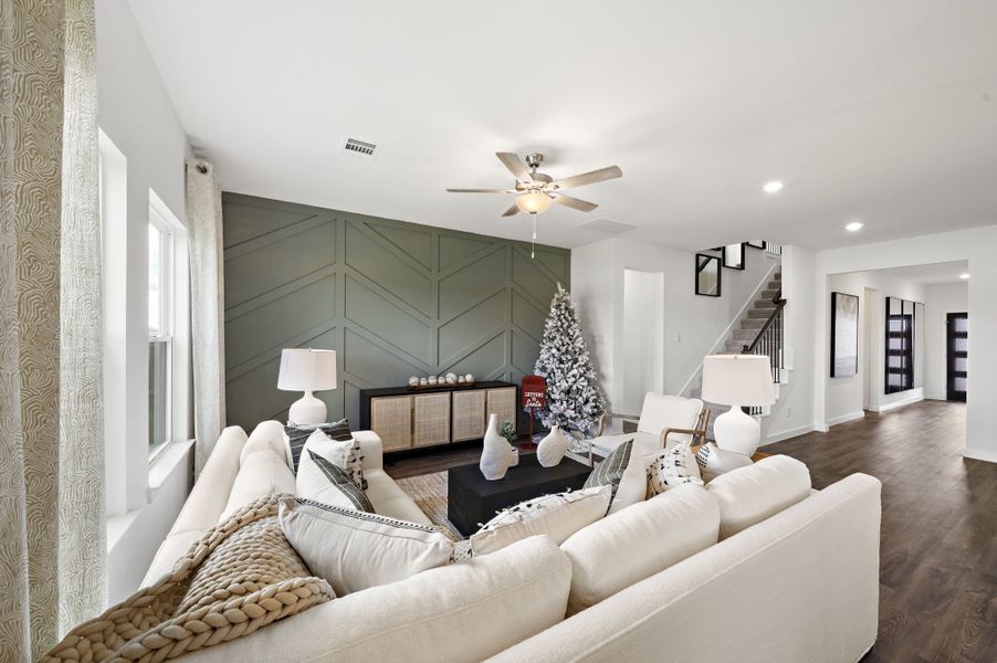 A living room with a couch and a chandelier. A living room with a couch and a chandelier.