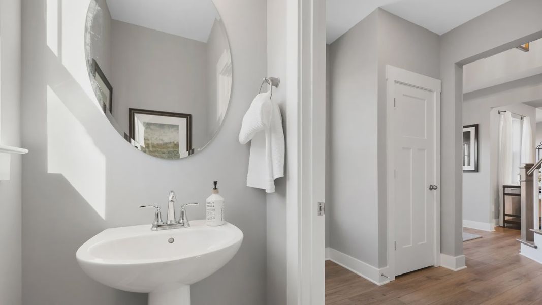 Polished nickel accented half bathroom with mirror
