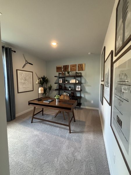 A modern home office with a sleek wooden desk, contemporary shelving, and stylish wall art.