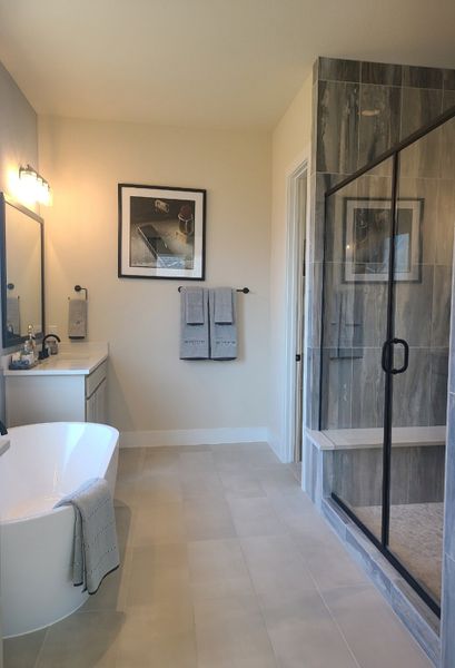 A modern bathroom featuring a sleek freestanding tub, spacious glass shower, and elegant vanity with contemporary fixtures. A modern bathroom featuring a sleek freestanding tub, spacious glass shower, and elegant vanity with contemporary fixtures.
