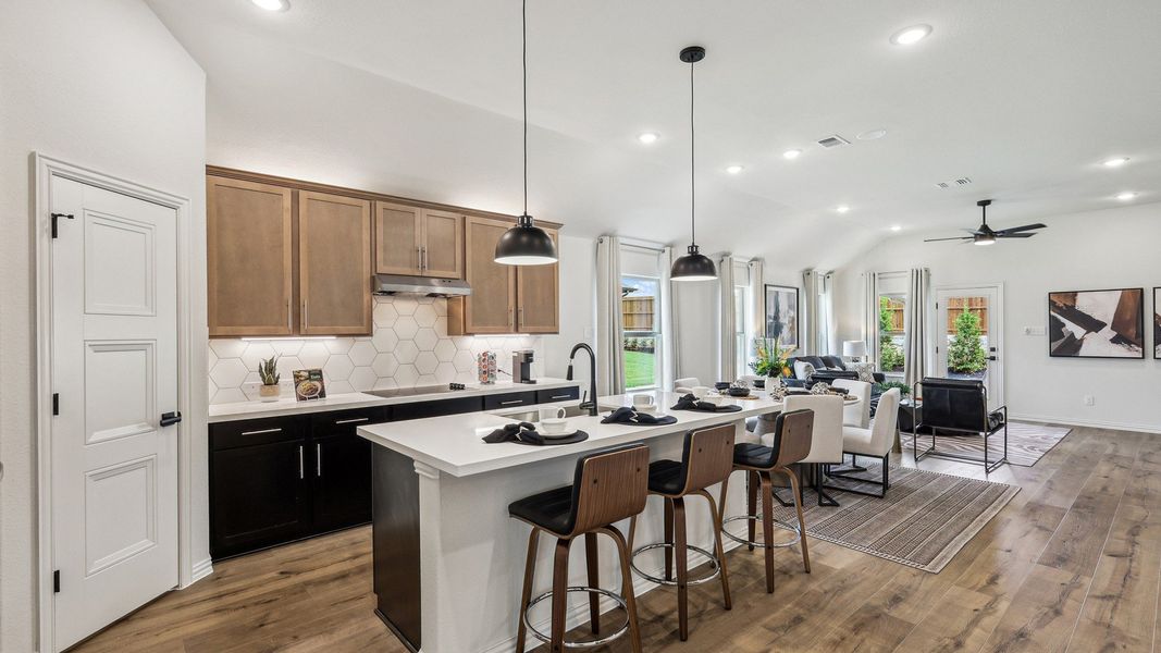 Elegant kitchen with hexagonal tile backsplash, wooden accents, and open-plan design in Churchill, Texas. Elegant kitchen with hexagonal tile backsplash, wooden accents, and open-plan design in Churchill, Texas.
