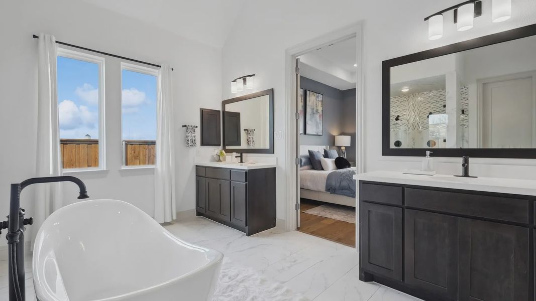 Luxurious bathroom features a sleek freestanding tub and dual vanities, exemplifying modern elegance in Westside Preserve.