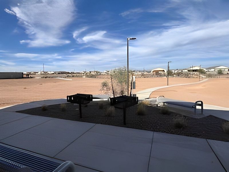A scenic view of a landscaped area with pathways and benches in The Ridge Collection at North Copper Canyon by Century Communities (Surprise, AZ).