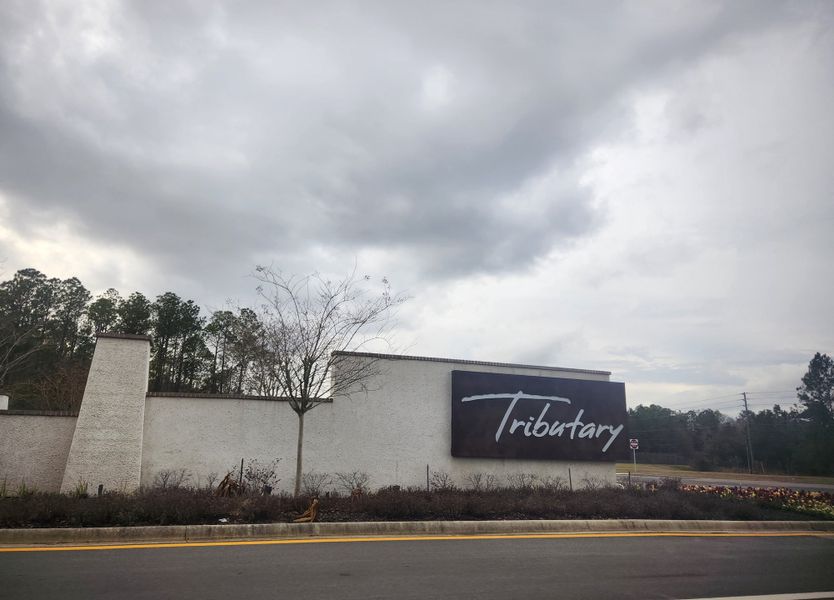 A modern entrance sign stands grandly at Tributary: Tributary Classic Collection by Lennar in Yulee, FL. A modern entrance sign stands grandly at Tributary: Tributary Classic Collection by Lennar in Yulee, FL.