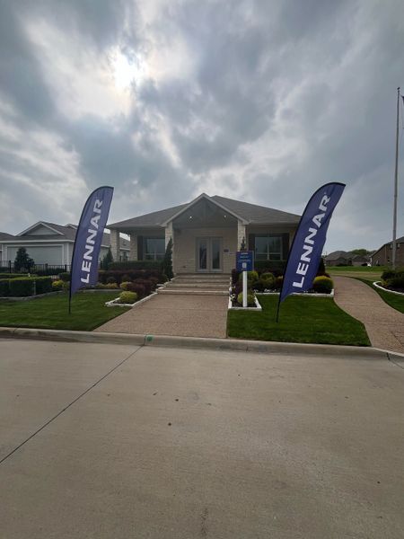 A charming model home with a welcoming porch and landscaped yard in Bridgewater: Classic Collection by Lennar (Princeton, TX).