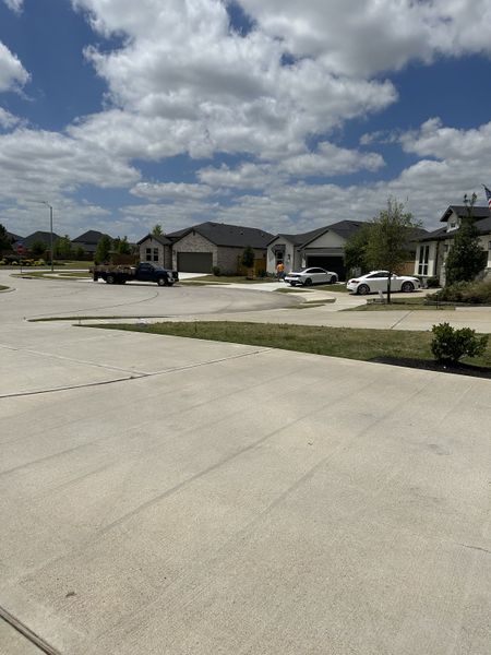 A peaceful suburban street with modern homes and landscaped lawns in Raburn Reserve 50s by Taylor Morrison (Tomball, TX). A peaceful suburban street with modern homes and landscaped lawns in Raburn Reserve 50s by Taylor Morrison (Tomball, TX).
