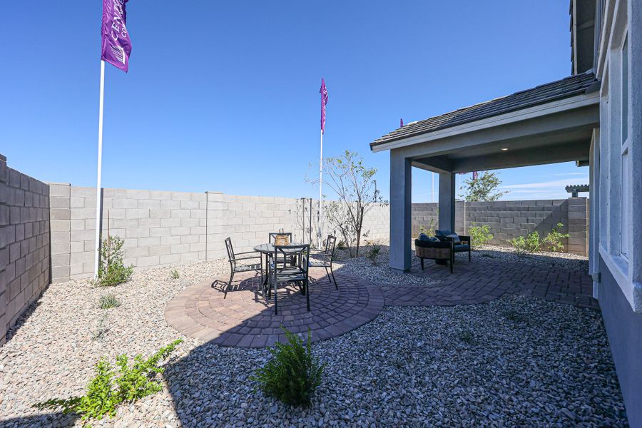 A patio with a table and chairs and a flag on it.