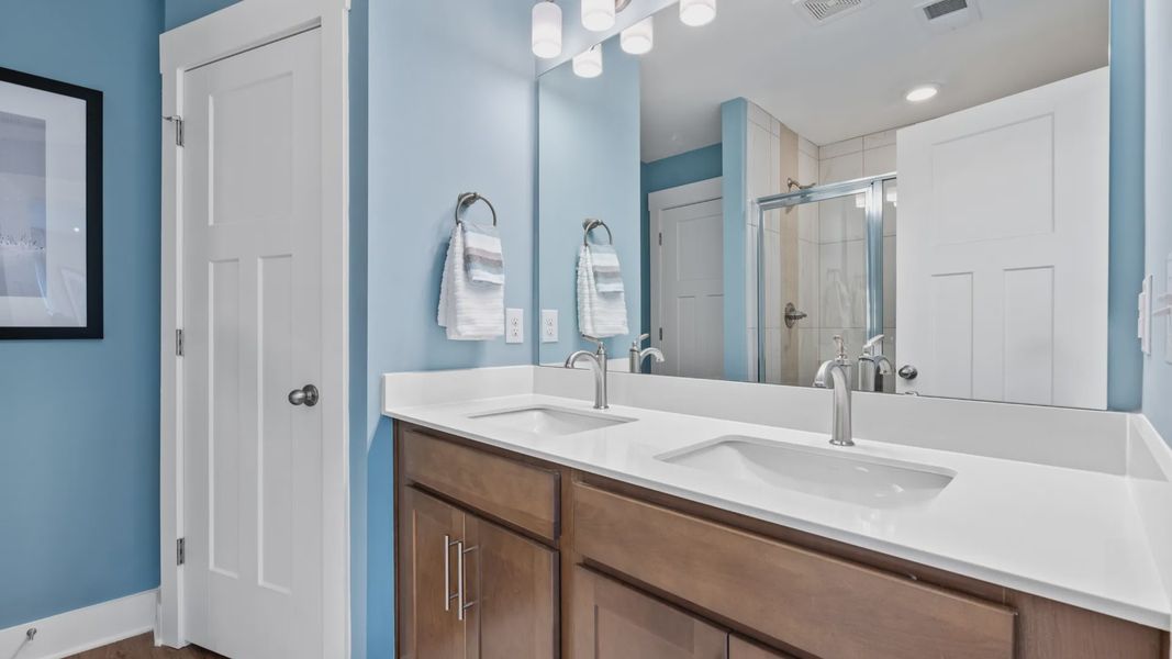 Spa-like primary bathroom with double sink vanity in two story townhome at Saluda Crossing by DRB Homes in Piedmont, SC
