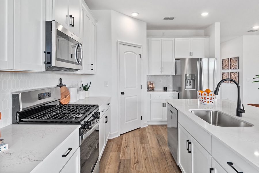 A kitchen with white cabinets. A kitchen with white cabinets.