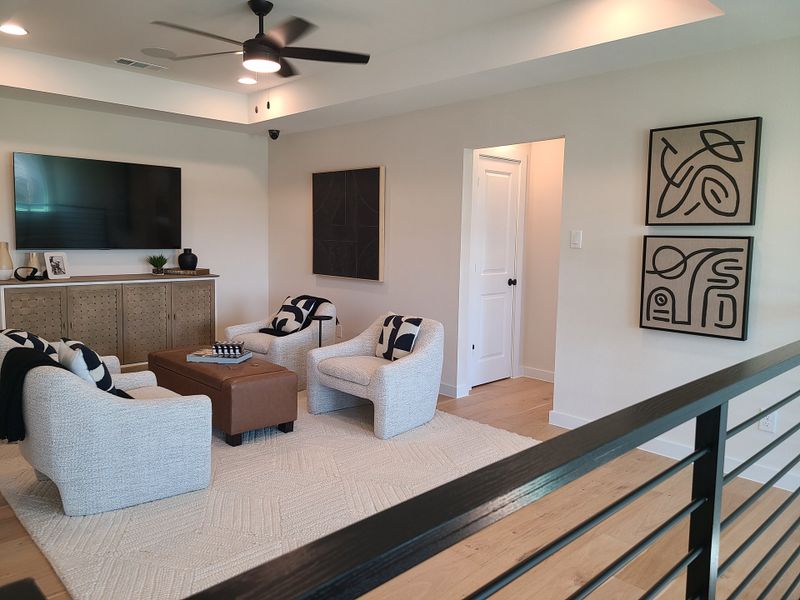 A modern living room with cozy armchairs, abstract art, and a large TV. Elegant decor and a warm, inviting atmosphere. A modern living room with cozy armchairs, abstract art, and a large TV. Elegant decor and a warm, inviting atmosphere.