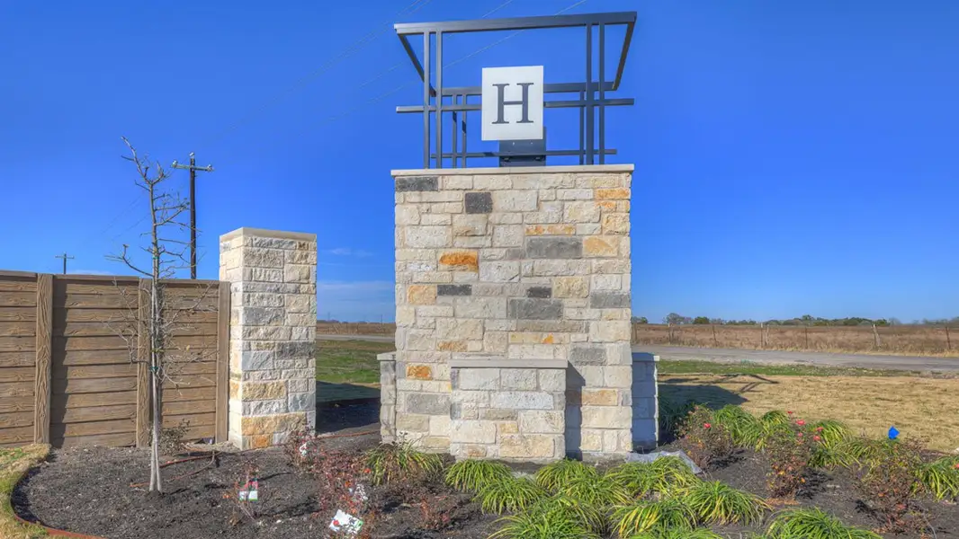 Entrance to the Hartland Ranch community in Lockhart, TX, featuring signage and landscaping (Image 7).